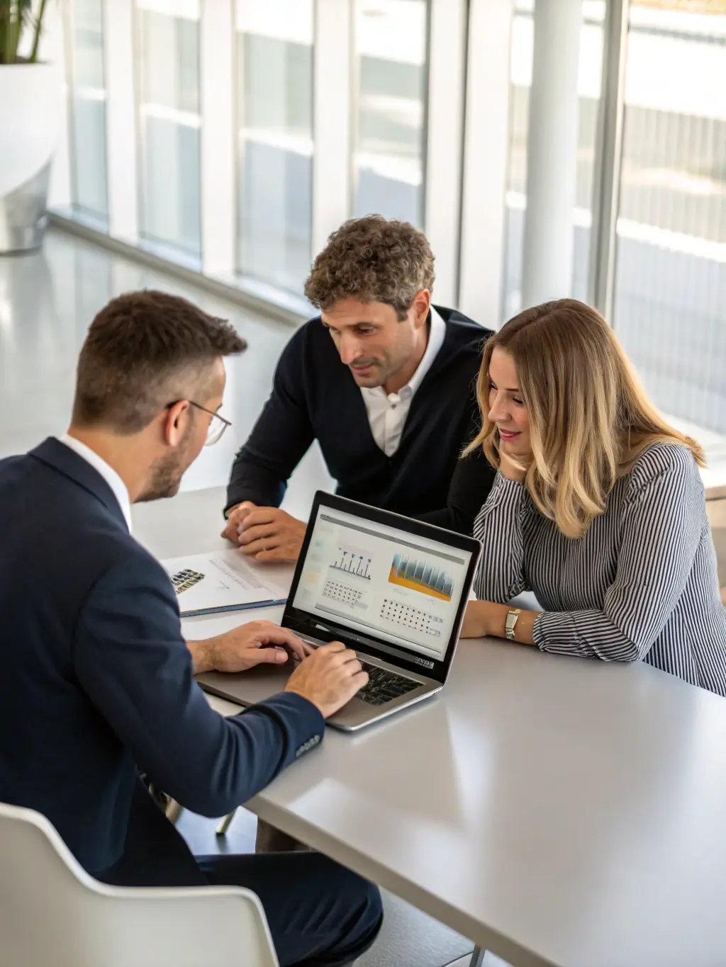 A professional image depicting consultants working with financial analysts in a modern office setting, emphasizing data analysis and strategic financial planning.